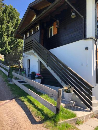 a house with stairs leading to the front door at Appartement Waidmannsheil mit schöner Aussicht in Grächen