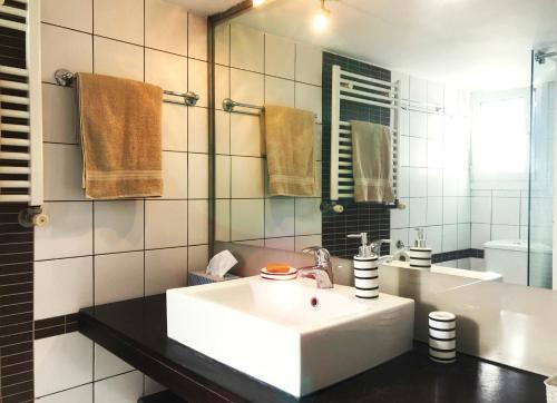 a bathroom with a white sink and a mirror at Athens by foot: Perfect flat with terrace in Athens