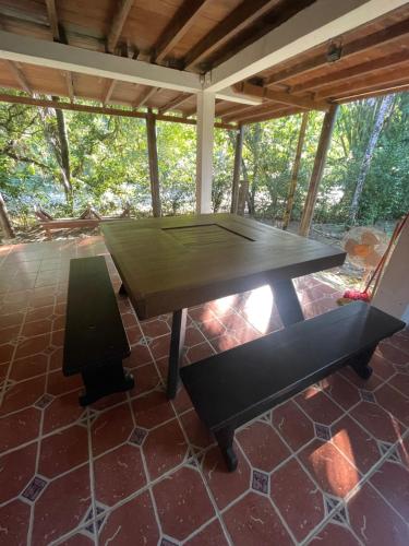 a ping pong table on a patio with a chair at Caoni Riverside Suites - Birders Paradise by the river, Ecuadorian Chocó in Puerto Quito