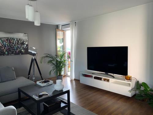 a living room with a large flat screen tv at Apartamenty przy Tężni in Busko-Zdrój