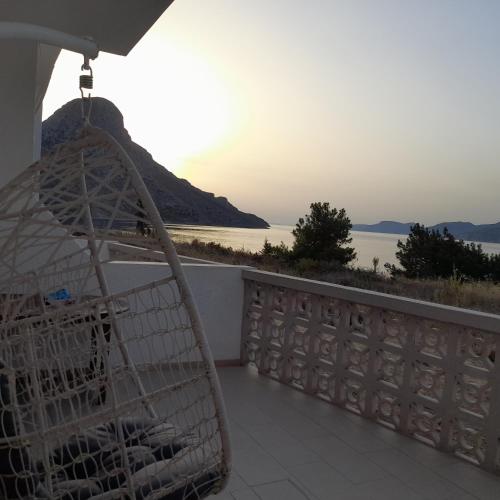 a basket on a balcony with a view of the ocean at Avra Studios in Masouri