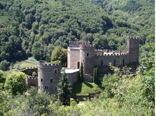 an old castle on a hill with a bridge at Hotel Restaurant Les Gorges de Chouvigny in Chouvigny