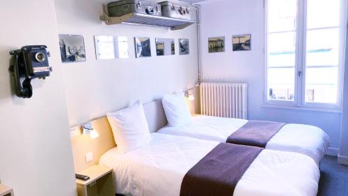 En eller flere senge i et værelse på Abelha Hôtel Le France