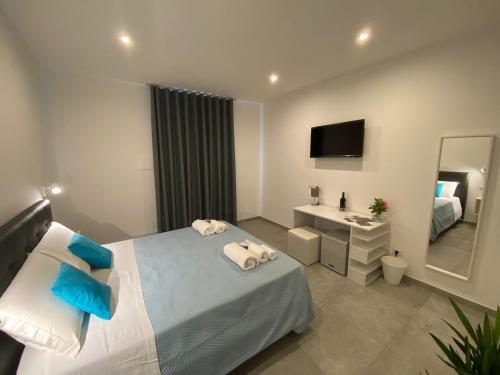 a bedroom with a bed and a sink and a mirror at InVilla Bed&Breakfast - Quality Rooms in Santa Maria di Castellabate