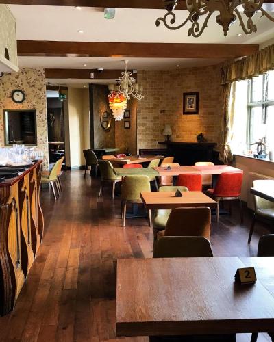 a restaurant with tables and chairs in a room at Albion Boutique Guest House in Sunderland