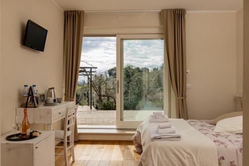a bedroom with a bed and a large window at Podere Belsogno in Montalcino