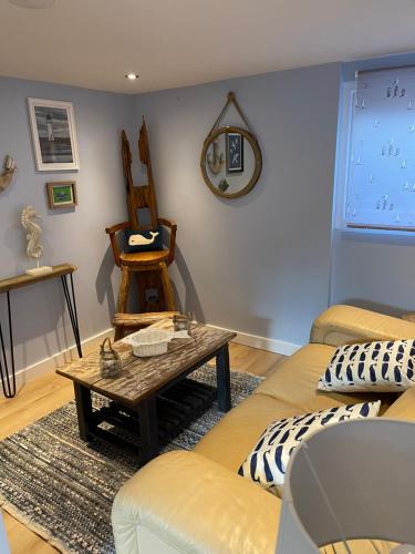 a living room with a couch and a table at Tiny Beach House in Saint Annes on the Sea