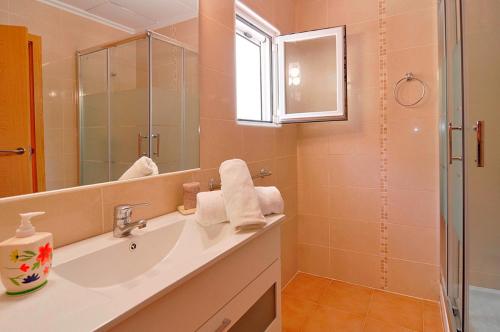 a bathroom with a sink and a mirror and a shower at Villa Mika in Jalón