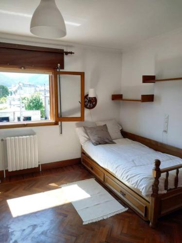 a bedroom with a bed and a large window at Covas Beach Arena in Viveiro