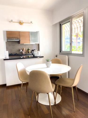 a kitchen and dining room with a table and chairs at Superb Apartment In Cannes With Magnificent View ! in Cannes