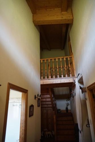 a stairway in a house with a wooden staircase at La Puerta de Gredos in San Martín del Pimpollar