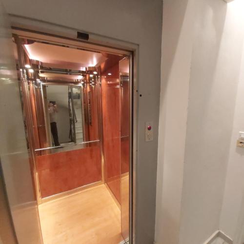 a shower in a room with a mirror at TSELIOS in Messini