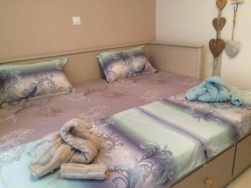 a bed with two towels and towels on it at Villa Vanya in Skala Rachoniou