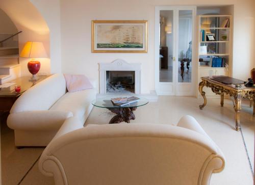 a living room with two white couches and a fireplace at La Dolce Vista - B&B di Charme in Manfredonia