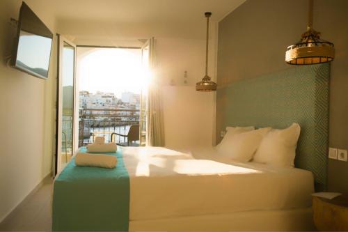 
a hotel room with a bed and a window at Hotel Port 7- Boutique Collection in Agios Nikolaos
