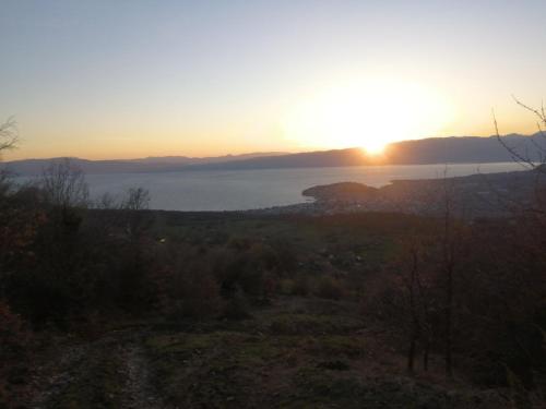 a sunset view of the ocean from a hillside at Villa Apartments STEFAN - Ramne Ohrid in Ohrid