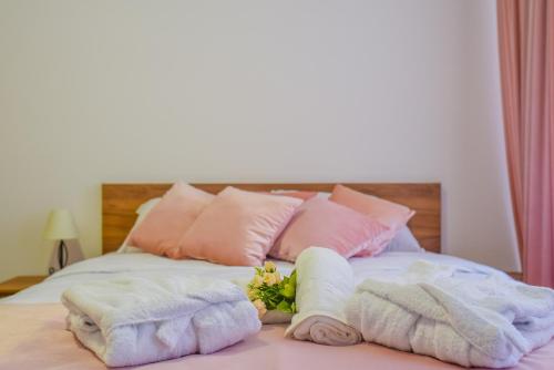 a bed with towels and pillows on top of it at Užički konak in Užice