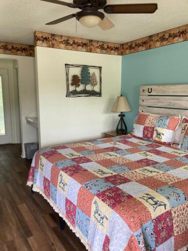 a bedroom with a bed and a ceiling fan at Horseshoe Riverside Lodge in Canyon Lake