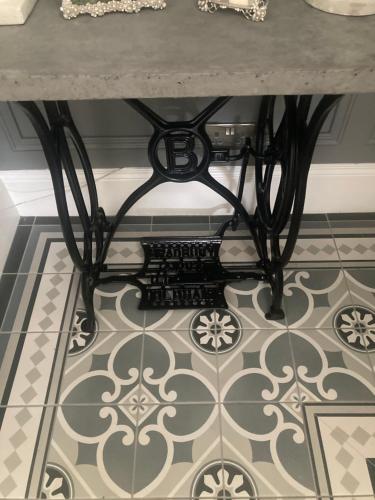 a table sitting on top of a tile floor at Ballyginniff Farm House in Crumlin