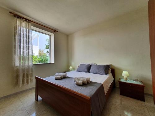 a bedroom with a large bed with two pillows on it at Via Ugento Apartments - a pochi passi dalle spiagge in Sant'Isidoro