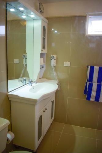 a bathroom with a sink and a mirror at Hotel Checkin El Cortecito Beach in Punta Cana