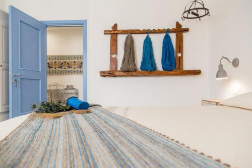 a room with a bed with a blue door at B&B Antico Telaio in Santa Maria Navarrese
