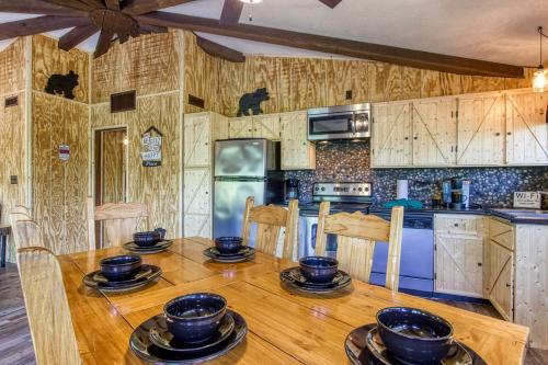 a kitchen with a wooden table with wooden chairs at Three Bears Den, Hot Tub, Pool table, Pool Access, 560 FREE tickets each paid day in Gatlinburg