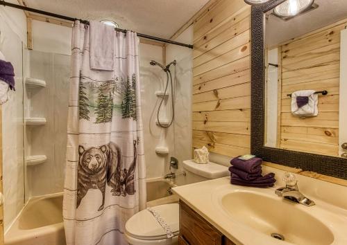 a bathroom with a shower curtain with a bear on it at Three Bears Den, Hot Tub, Pool table, Pool Access, 560 FREE tickets each paid day in Gatlinburg