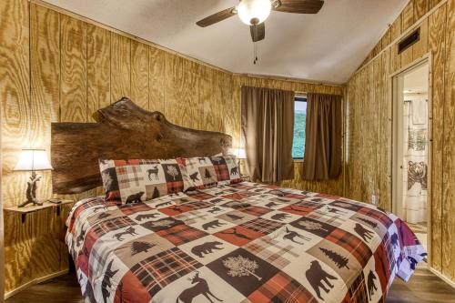 a bedroom with a bed with a quilt on it at Three Bears Den, Hot Tub, Pool table, Pool Access, 560 FREE tickets each paid day in Gatlinburg