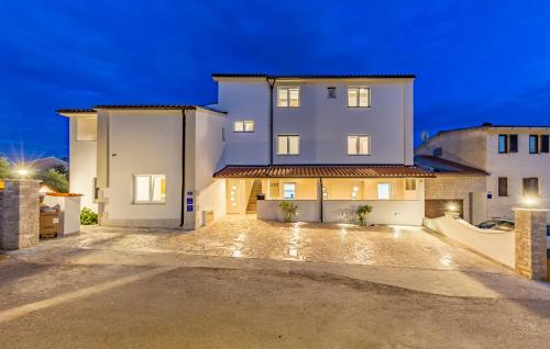 a large white house with a driveway at night at Villa Asta Medulin in Medulin