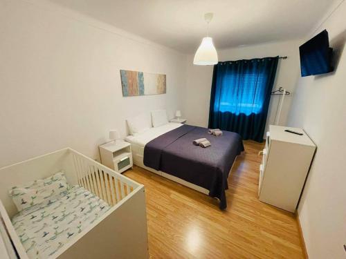 Amoreira的住宿－Soares Village II，一间带一张床和一张婴儿床的小卧室