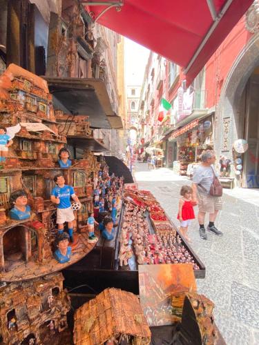 a group of toy dolls on display in a market at Hotel Europeo Napoli in Naples