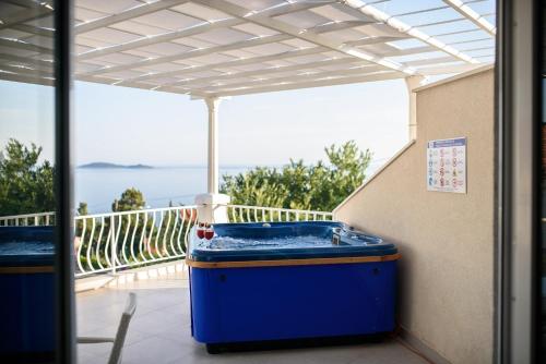 a hot tub on the balcony of a house at Aurora Seaview Apartment in Mlini