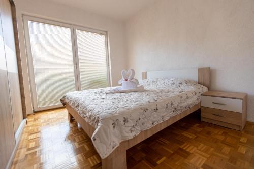 a bedroom with a bed with a stuffed animal on it at S-Apartment Ohrid in Ohrid