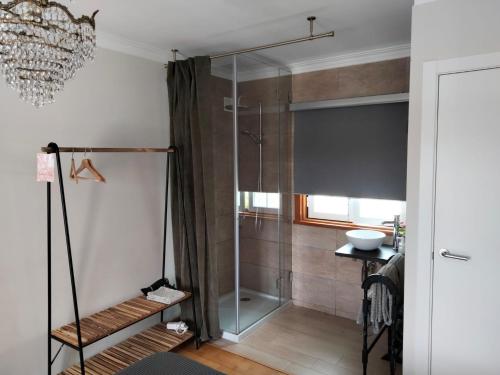 a shower with a glass door in a bathroom at Galo Preto - Sintra Guesthouse in Sintra