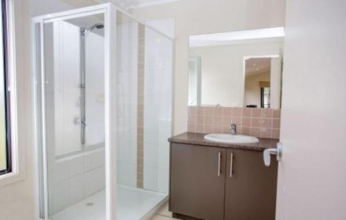 a bathroom with a shower and a sink and a shower at Discovery Parks - Geelong in Geelong