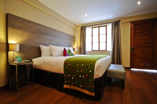 a hotel room with a large bed and a window at Union Hotel Cusco in Cusco