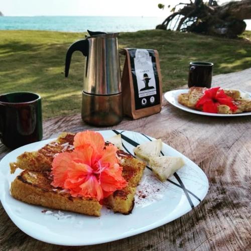 a plate of toast with flowers on top of a table at Cafe del Mar Sapzurro in Sapzurro