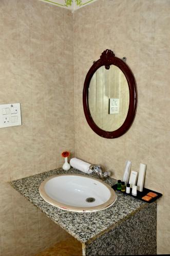 a bathroom with a sink and a mirror at Mahal Rajwada-A Heritage Resort in Jaipur