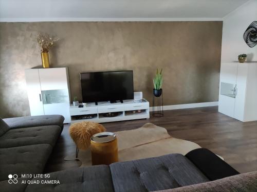 a living room with a couch and a flat screen tv at Apartment Marco in Zadar