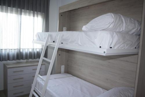 Tempat tidur susun dalam kamar di AR Apartamentos