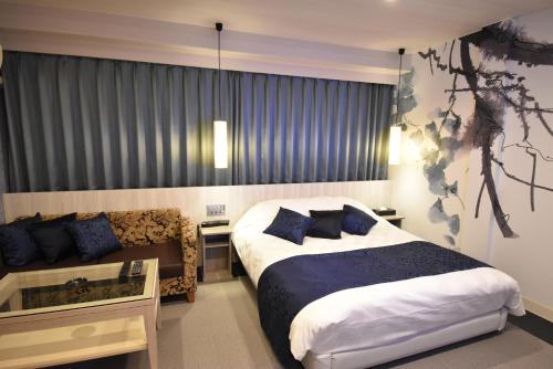 מיטה או מיטות בחדר ב-HOTEL IORI - Adult Only