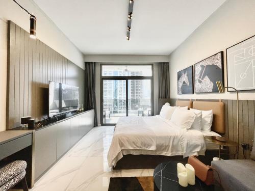 a bedroom with a large bed and a television at Excelsior VIII - MAG 318 in Dubai