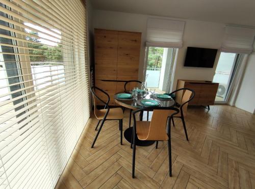 a dining room with a table and chairs at GOLDEN SANDS in Rowy