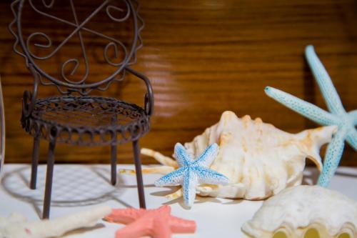 a table with a chair and starfish on it at 北谷日漁別荘 in Chatan