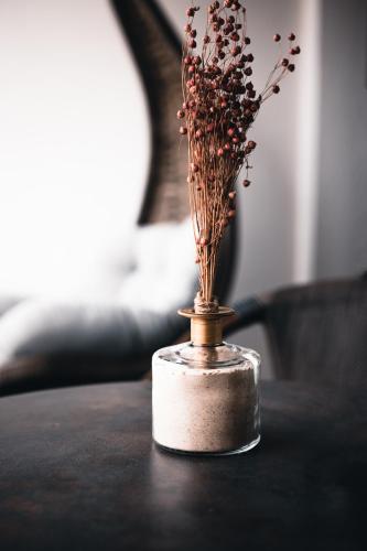 a small vase with flowers in it on a table at CHRIStania in Fiesch