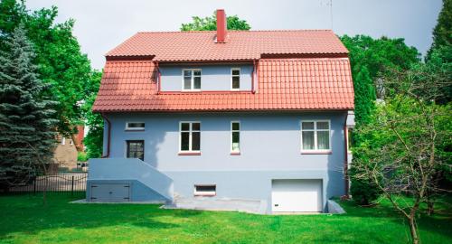 a white house with a red roof at Liepa in Šilutė