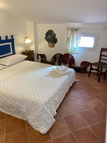a bedroom with a bed and a table and chairs at La Casa Rossa in Maiori