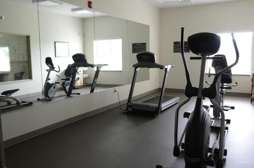 a gym with exercise bikes and a mirror at Sleep Inn & Suites Cave City in Cave City