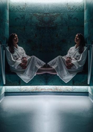 two women sitting on the floor in a dark room at CHRIStania in Fiesch